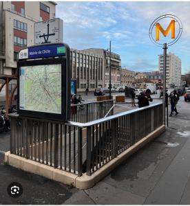 a bus stop sign with a map on a fence at Lavenir in Clichy