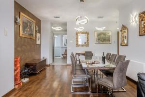 a dining room with a table and chairs at Grand Square Suite - Tale Of The City in Zagreb