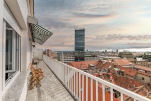 a balcony with a view of a city at Grand Square Suite - Tale Of The City in Zagreb