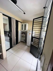 a kitchen with a refrigerator and a staircase in a room at Casa p o São João em Caruaru-PE in Caruaru
