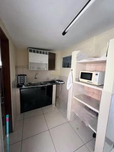 a kitchen with a sink and a microwave at Casa p o São João em Caruaru-PE in Caruaru