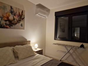 a bedroom with a bed and a window and a shelf at Holiday in Trebinje Apartment in Trebinje +15 photos