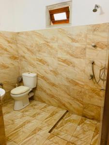 a bathroom with a toilet and a shower at Four Seasons Villa in Anuradhapura