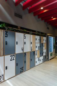 a row of lockers with numbers on them in a room at My pod Capsule Boutique Airport in Ezeiza
