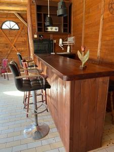 a kitchen with a wooden bar with a sink at Łęgowska Dolina in Olecko