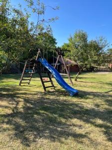 a playground with a slide in a yard at Łęgowska Dolina in Olecko