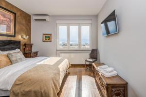 a bedroom with a large bed and a window at Grand Square Suite - Tale Of The City in Zagreb