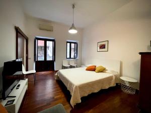 Schlafzimmer mit einem Bett und einem Flachbild-TV in der Unterkunft Suite Mamo in Palermo