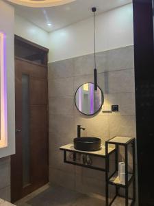 a bathroom with a sink and a mirror at Isabirye residence in Kampala