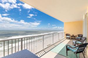 a balcony with chairs and a view of the ocean at San Carlos 1503 in Gulf Shores