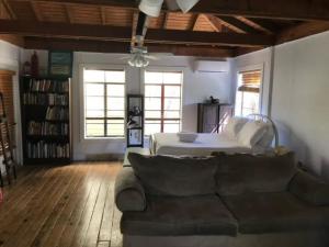 a living room with a couch and a bed at Acadiana Hideaway Tiny House in Lafayette