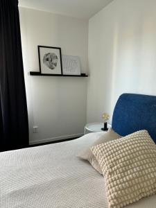 a bedroom with a bed and a blue chair at Tranquil and Convenience Southern Malmo Apartment in Malmö