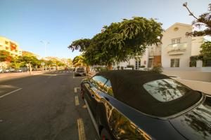 a car parked on the side of a street at Playa Fanabe in Adeje