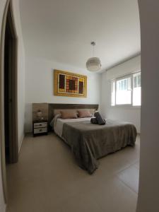 a bedroom with a large bed in a white room at Chalet adosado acogedor Busot in Alicante +20 photos
