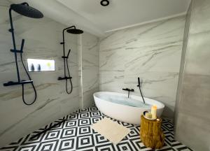 a bathroom with a white tub and a shower at Hotel Rural Flor de Almendro in Loarre +36 photos