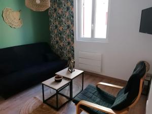 a living room with a couch and a table at Logement Soulac-sur-mer 4 personnes in Soulac-sur-Mer