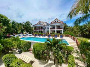 an aerial view of a house with a swimming pool at VeLento Partial Ocean View Penthouse #7 in Caye Caulker