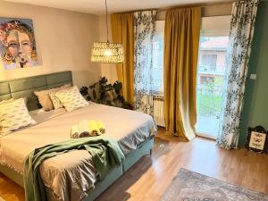 a bedroom with a bed and a large window at Veronika's House in Pula