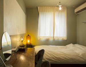 En eller flere senge i et værelse på Apartment Hotel Shinjuku