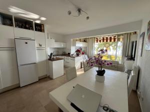Una cocina con una mesa con una computadora portátil encima. en 2p front de mer bocca cabana, en Cannes
