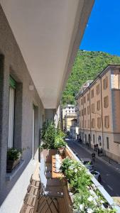 a balcony with chairs and plants on a building at The window on the theatre and the cathedral - Luxury apartment in Como