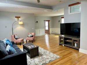 a living room with a couch and a flat screen tv at Spacious Medford Gem in Medford