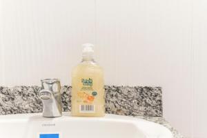 a bottle of orange juice sitting on top of a sink at Loft Urbano en Medellín Pet Friendly 105 in Medellín