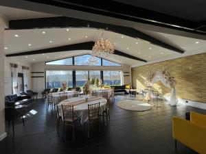 a banquet hall with tables and chairs and a chandelier at Luxry Villa in Pottum in Pottum