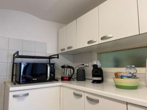 a kitchen with a counter top with a microwave at Dolce vita Assisi flat two bedrooms two bathrooms in Assisi +17 photos