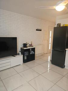 a living room with a large flat screen tv at KIFKIF in Saint-Germain-lès-Arpajon