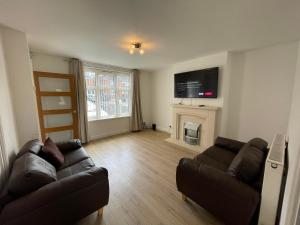 a living room with a couch and a fireplace at 2BR 15 min to BHX Airport 5 min to Heartlands in Birmingham
