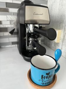 a coffee maker with a cup of coffee on a coaster at Sweet Home in Carolina