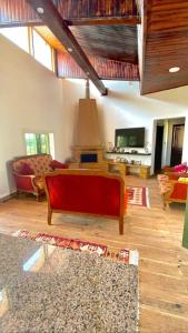 a living room with a red couch and a tv at Mountain farm in Ajloun