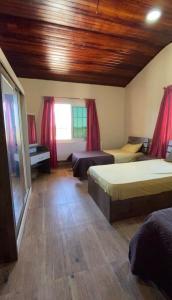 a large room with two beds and a window at Mountain farm in Ajloun