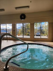 a swimming pool with a hot tub at Luxury Inn & Suites in Silverthorne