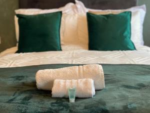 a towel on a bed with a glass on it at Luxury Home In Brickhill Group Stay FAST Wifi FREE Parking in Bedford +34 photos