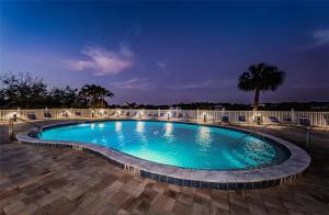 a large swimming pool at night at Bayshore Yatch Tennis Condo 2br 3 beds, Walking Distance to Beautiful Quite Beach in Clearwater Beach