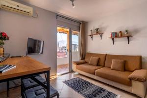 a living room with a couch and a table at NEW BAZAAR Apartment in Tirana