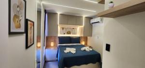 a small room with a bed with towels on it at Hamptons João Pessoal in João Pessoa +11 photos