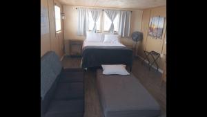 a small bedroom with a bed and a couch at StarGazer Hidaway in Bisbee