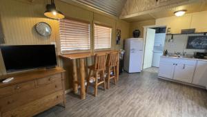 a kitchen with a television and a kitchen with a counter at StarGazer Hidaway in Bisbee