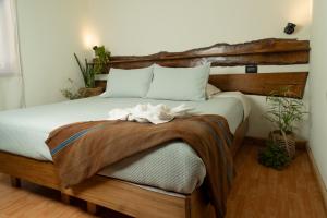 1 dormitorio con 1 cama grande y cabecero de madera en Hotel y Restaurant Doña Rode en Andacollo
