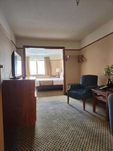 a living room with a couch and a room with a bed at Luxury Inn & Suites in Silverthorne