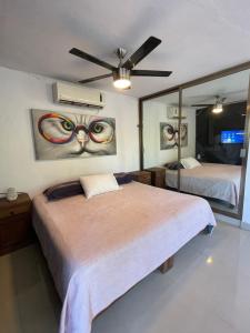 a bedroom with two beds and a large mirror at Departamento Santa Ana in Valladolid