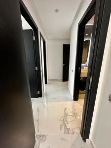 a hallway with marble flooring in a building at Appartement Prestigia 3 chambres in Marrakesh