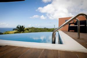 a swimming pool next to a house at Bocean Villa- Luxury Hilltop Retreat in Canaries