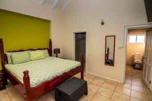 a bedroom with a bed with a green wall at Bocean Villa- Luxury Hilltop Retreat in Canaries +20 photos