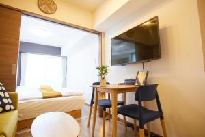 Habitación pequeña con escritorio, cama y ventana en SG Premium KASAI - Vacation STAY 44266v en Tokio