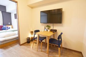 a room with a table and a bed and a mirror at SG Premium KASAI - Vacation STAY 44284v in Tokyo