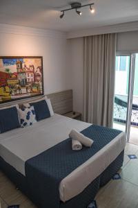 a bedroom with a large bed with a towel on it at Pousada Bahia Inn in Morro de São Paulo